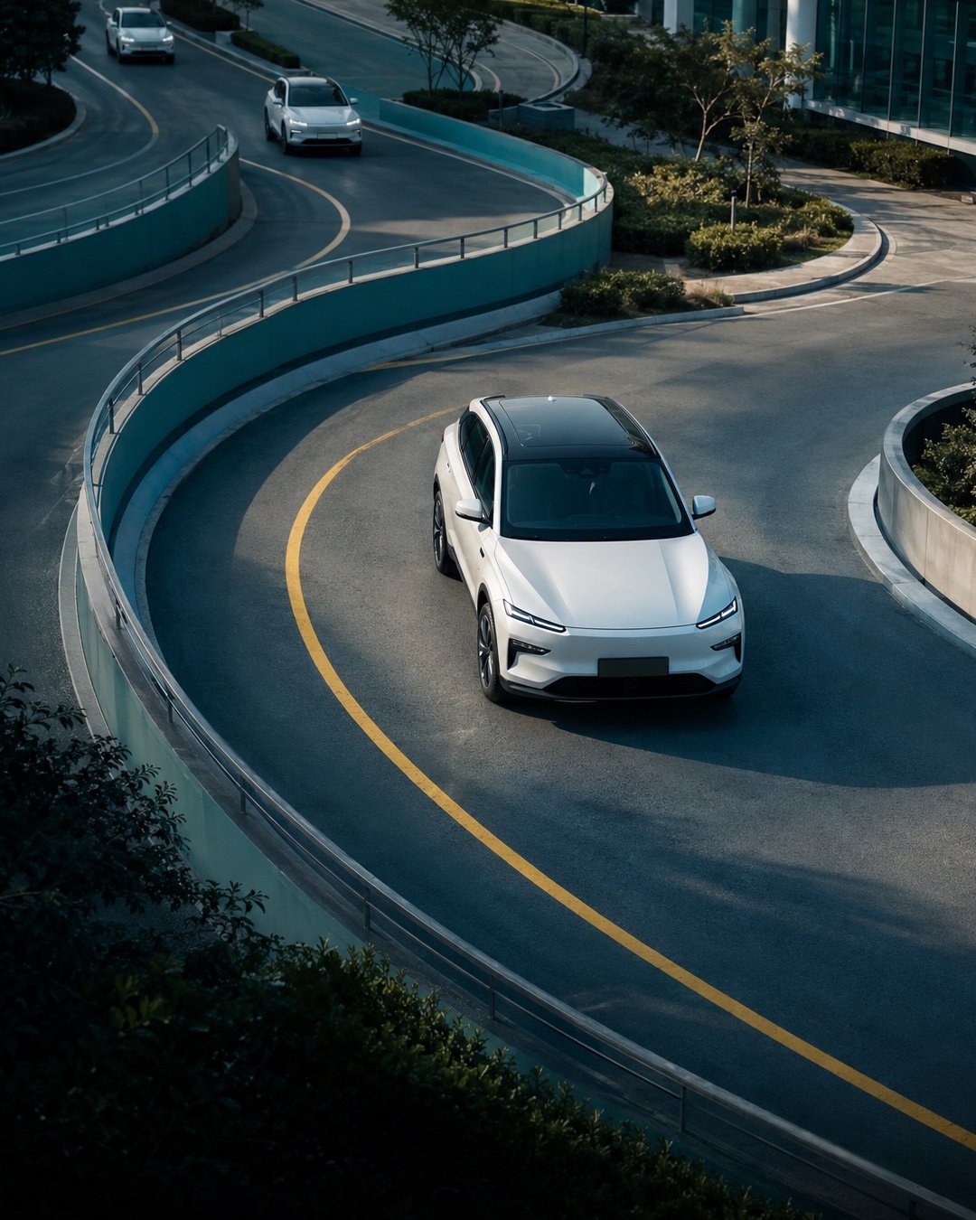 An electric vehicle following a sweeping road through a modern business campus