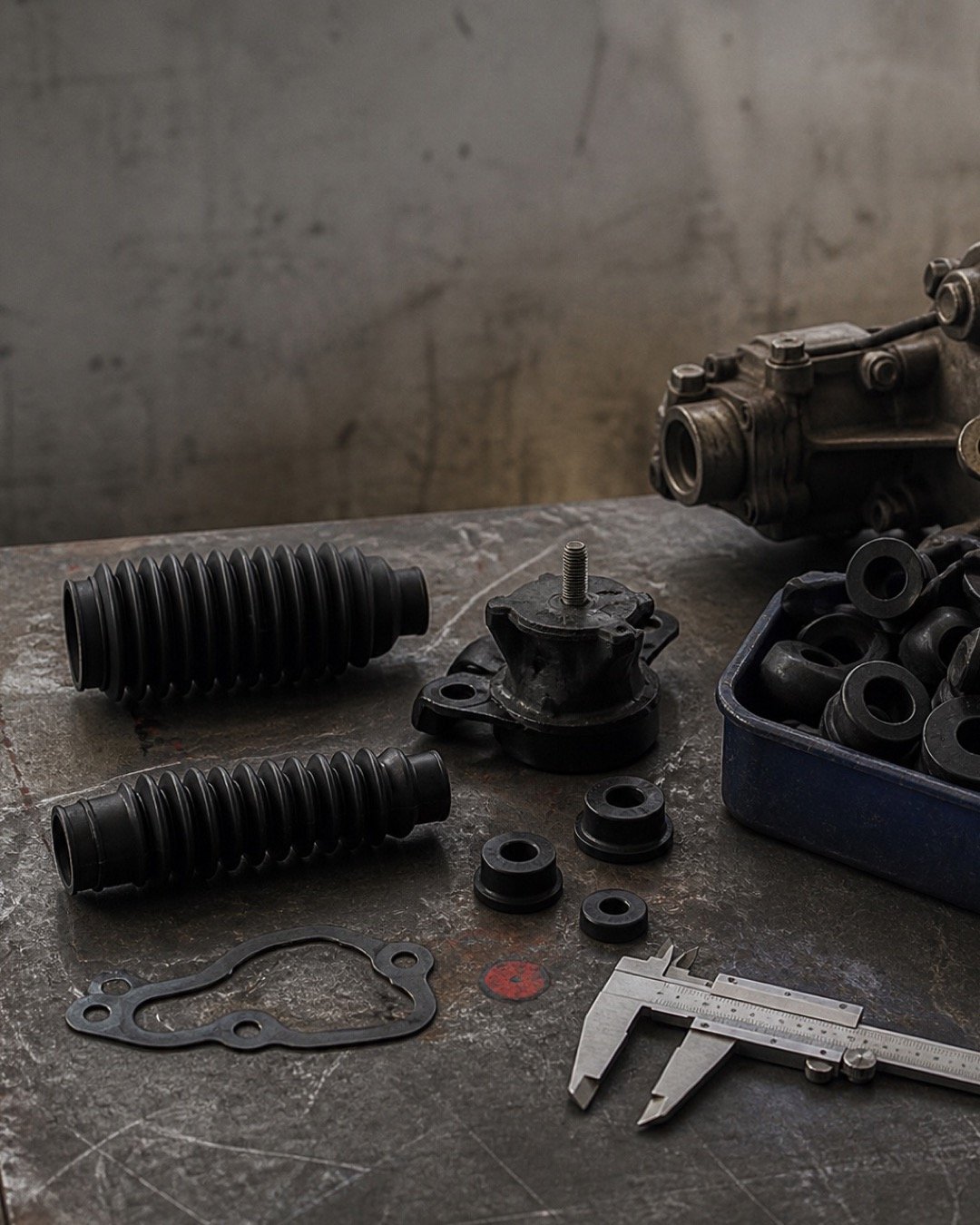 Precision-moulded black rubber components arranged with a metal automotive assembly